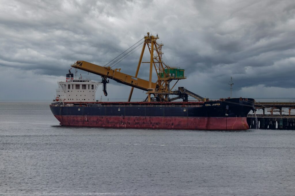 Cargo vessel with cranes at a loading terminal